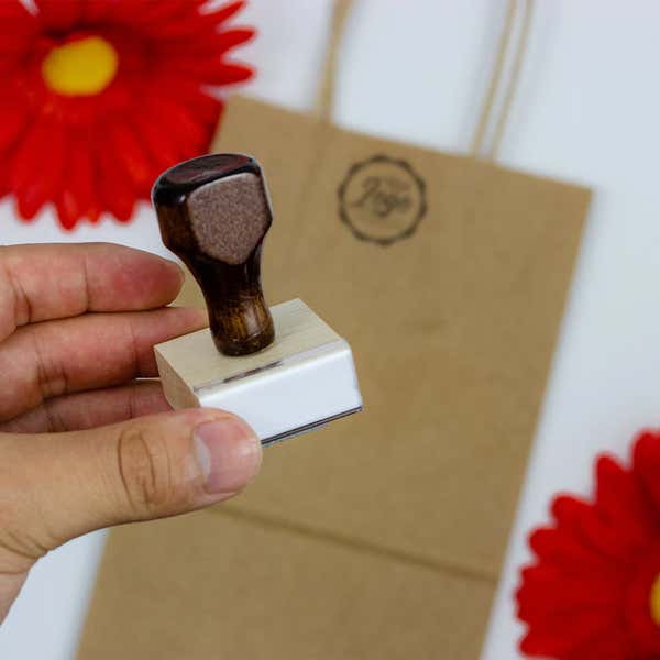 Example of 1 inch custom logo stamp with bag in background