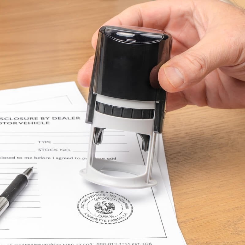 Round notary seal being pressed onto an official document
