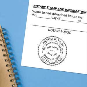 Notary public stamp impression on signed document above notebook