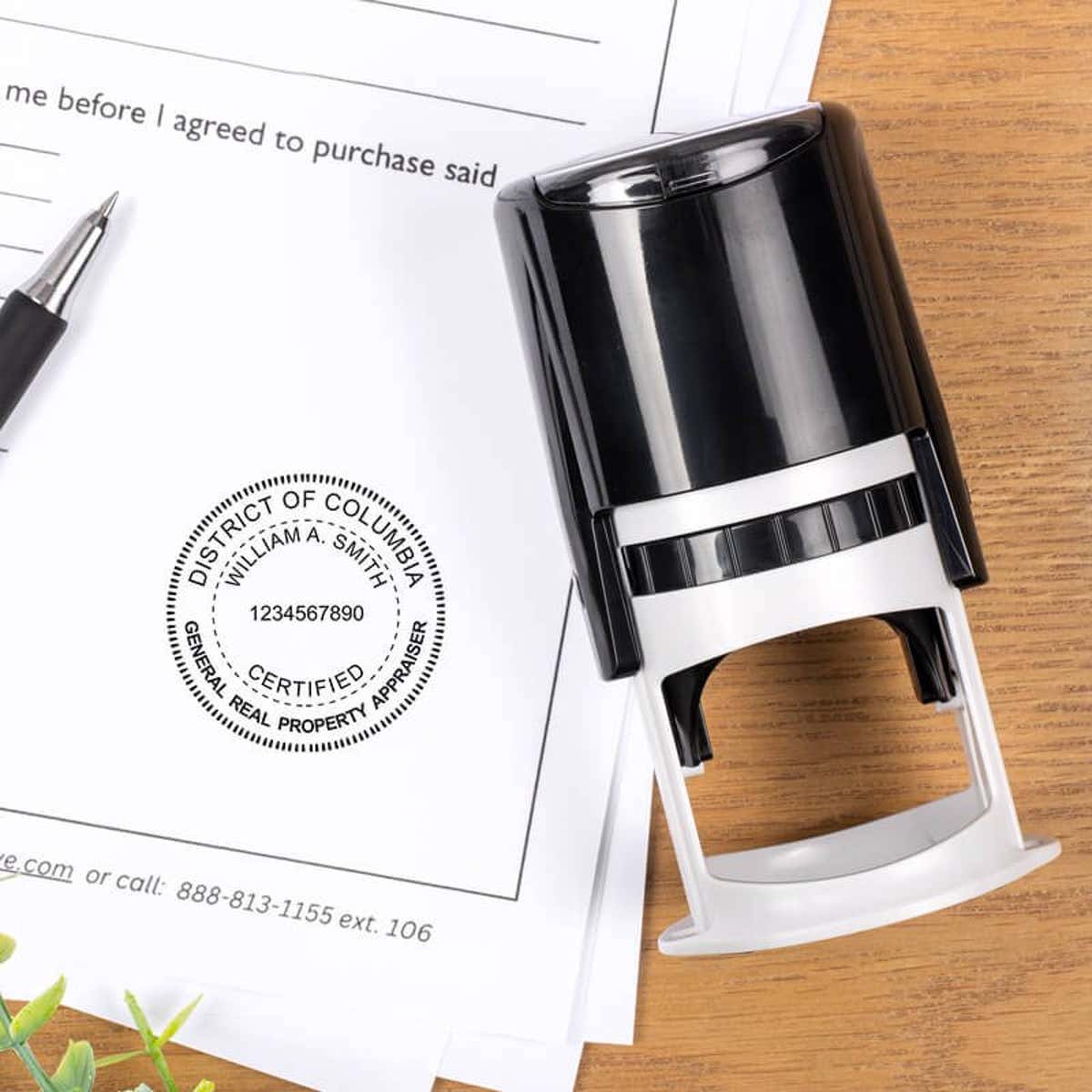 A self-inking stamp placed next to the District of Columbia Real Estate Appraiser Seal at the bottom of a document