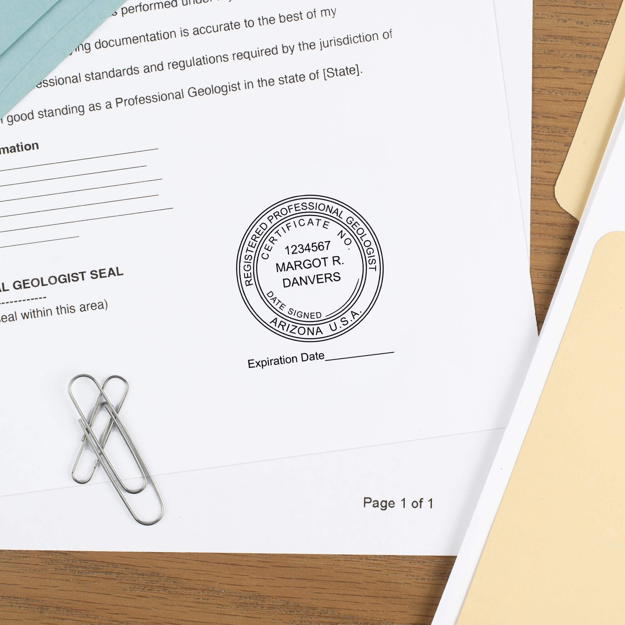 The State of Arizona Geologist with Expiration Seal impression at the bottom of a document wood table