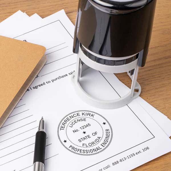 Florida engineer seal on form with stamp and pen on desk