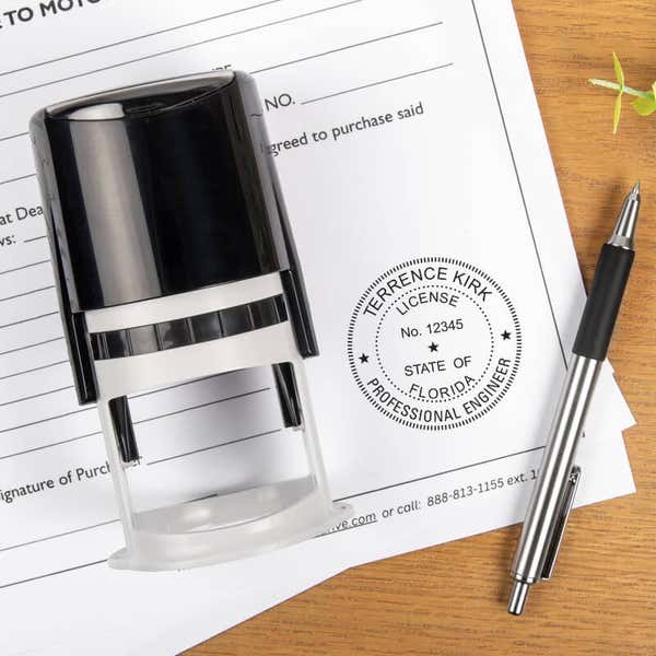 Engineering license stamp next to completed paperwork