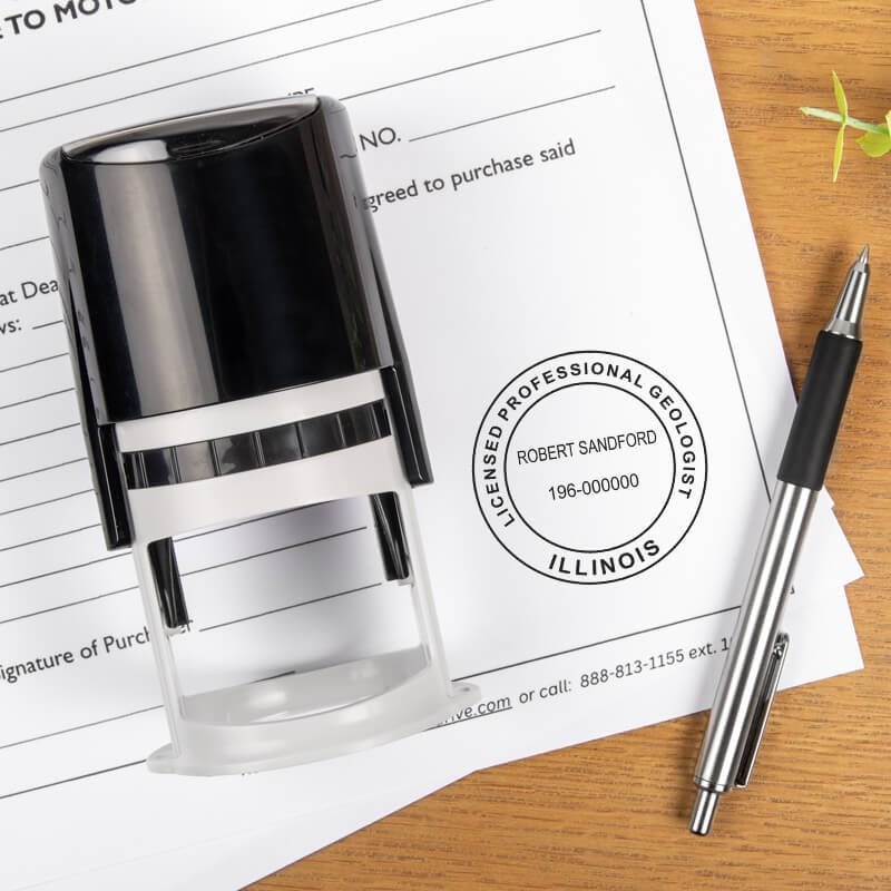 A self-inking stamp and a pen placed next to the State of Illinois Geologist Seal 
