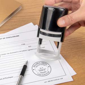 The State of Indiana Land Surveyor Seal being used on a document with a self-inking stamp