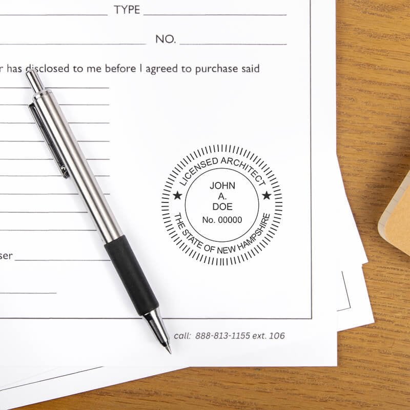 The State of New Hampshire Architect Seal on a document next to a pen