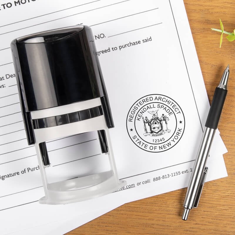 State of New York Architect stamp on a document next to the stamp body and a pen