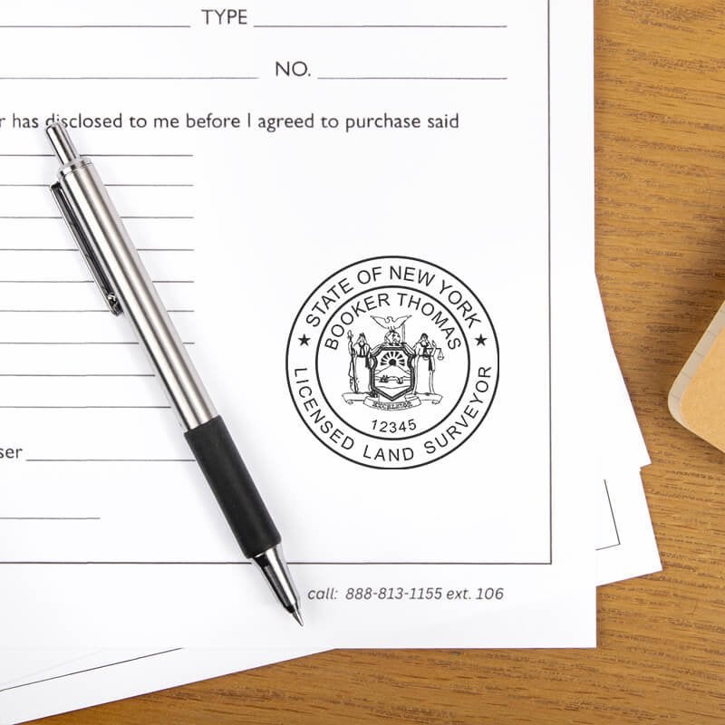The New York Land Surveyor Seal on a document next to a pen