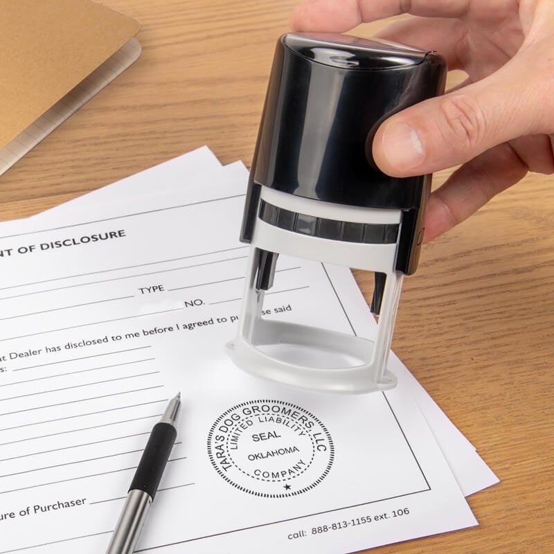 The Oklahoma Business LLC Stamp Seal being used on a document
