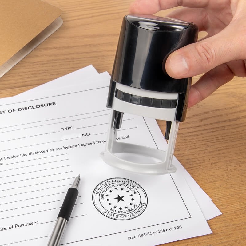 The State of Vermont Architect Seal being used on a document with a self-inking stamp