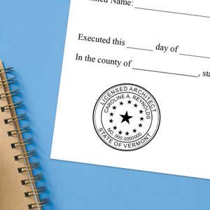 The State of Vermont Architect Seal at the bottom of a document next to a pen