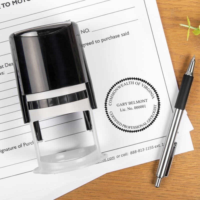 A self-inking stamp and a pen placed next to the State of Virginia Geologist Seal