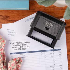 Trodat Printy 4925 self-inking business stamp placed on a sales receipt