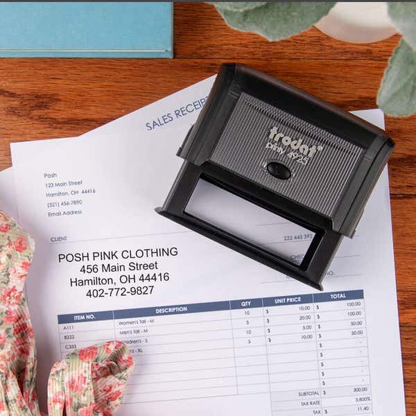 Trodat Printy 4925 self-inking business stamp placed on a sales receipt