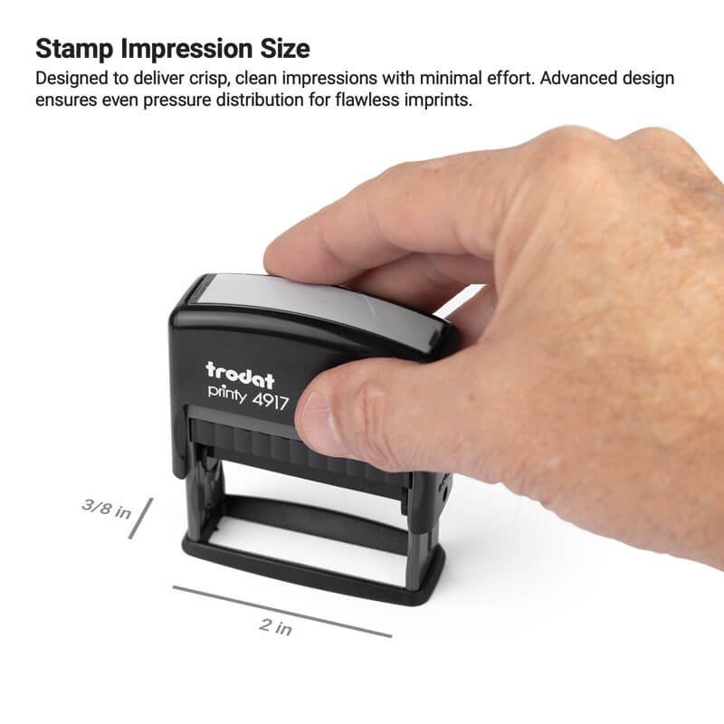 Hand holding a Trodat Printy 4917 stamp with 3/8" x 2" impression size, positioned to apply a slim mark on office documents