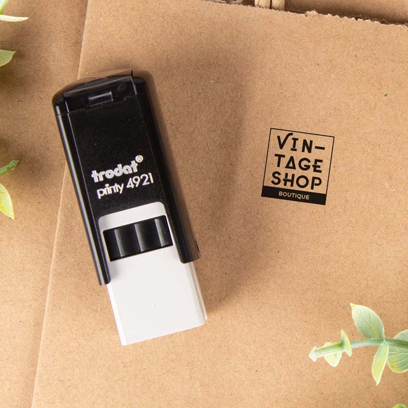 Personalized  logo stamp used for boutique packaging, shown stamping a 'Vintage Shop' brand mark on kraft paper for small business branding.