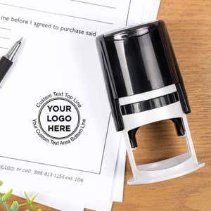 Custom round stamp and impression on document with pen and wood desk background.