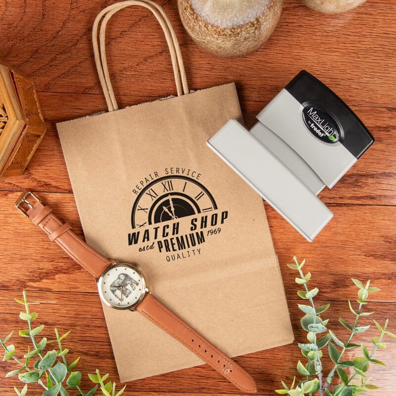 Example of the MaxLight logo stamp being used to brand a kraft paper bag