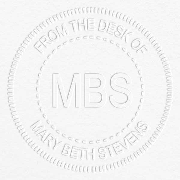 Custom Initial Embosser impression on grey paper