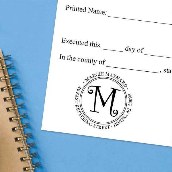 Stamped document featuring a custom return address stamp with a decorative “M.”