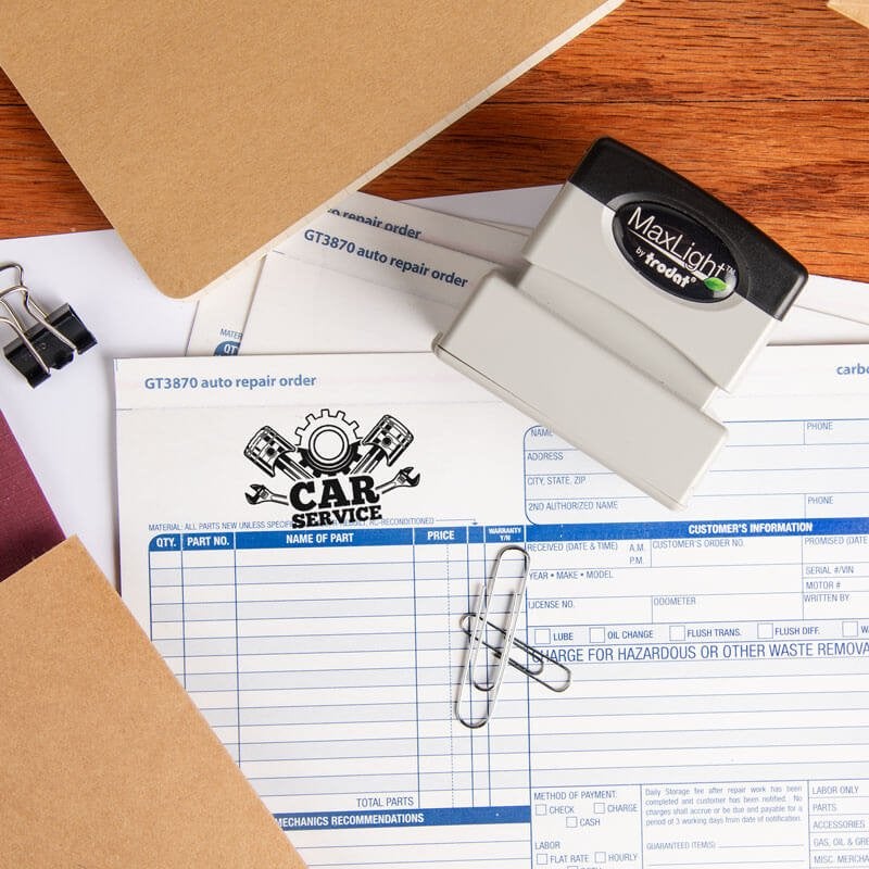 MaxLight custom logo stamp placed on top of a stamped invoice