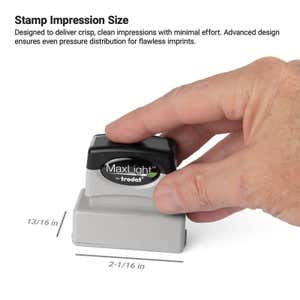 Hand pressing down on a MaxLight by Trodat pre-inked stamp measuring 2-1/16" wide by 13/16" high.
