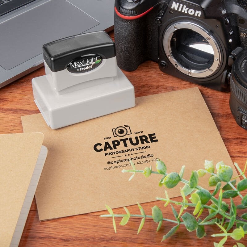 MaxLight custom stamp used to imprint a photography studio logo on kraft envelope