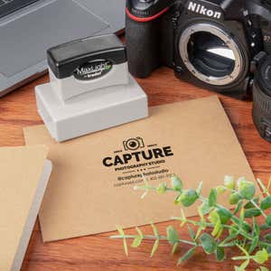 MaxLight custom stamp used to imprint a photography studio logo on kraft envelope
