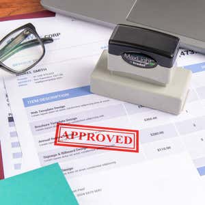 MaxLight by Trodat pre-inked stamp laying on paperwork sample with a red "APPROVED" stamp impression