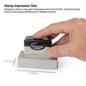 Hand holding a pre-inked stamp with an impression size labeled as 1-1/16" x 2-7/8" 