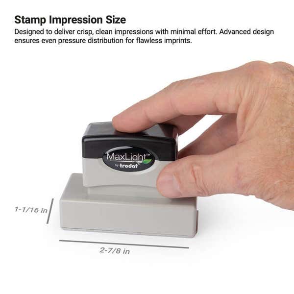 Hand holding a pre-inked stamp with an impression size labeled as 1-1/16" x 2-7/8" 