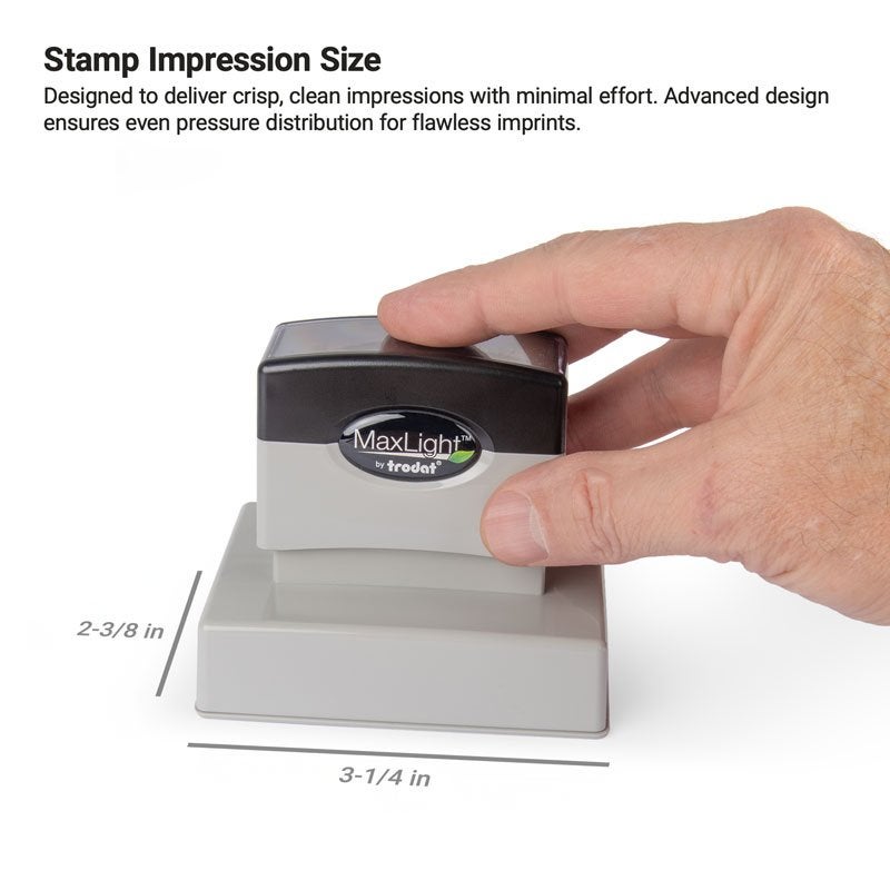 Hand holding MaxLight stamp, showing an impression size that measures 2-3/8" x 3-1/4"