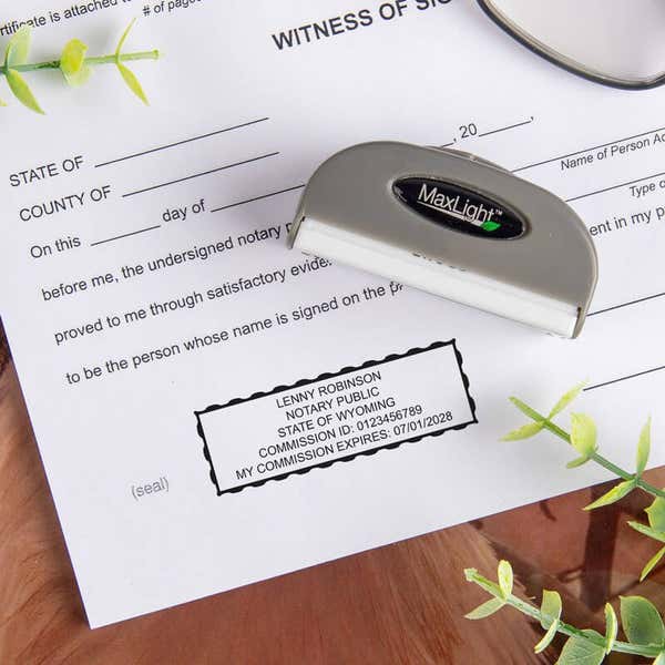 Notary stamp being used on a legal document, showing a professional imprint 