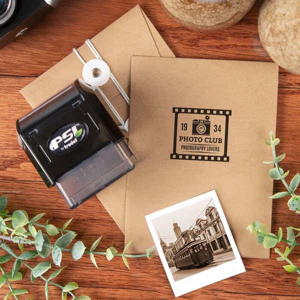 PSI pre-inked stamp shown next to a kraft envelope stamped with a square logo print example