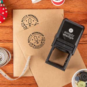 Simply Stamps self-inking stamp shown with a circular custom logo that has been applied to envelopes