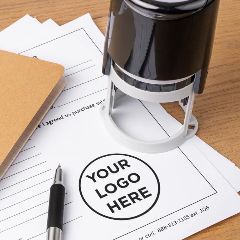 The round logo stamp body next to a stamp impression on the bottom of a document