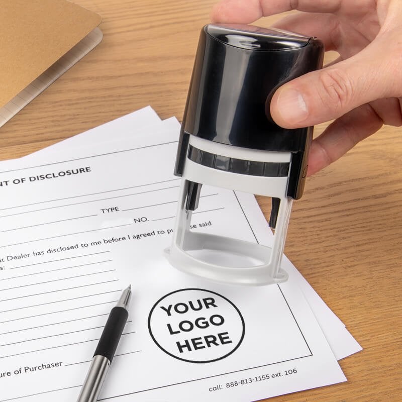 The round logo stamp being used on an official document