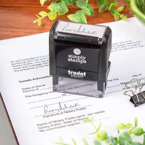 Trodat Printy 4912 stamp resting on a completed notary acknowledgment form