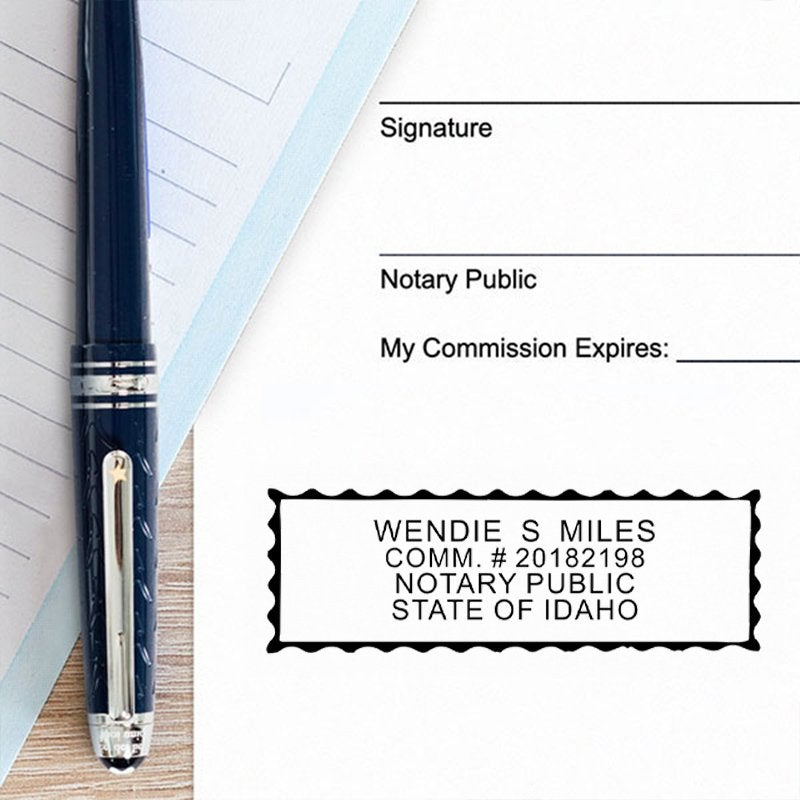 Impression on paper next to a pen for the Idaho Notary Pink Stamp - Rectangle