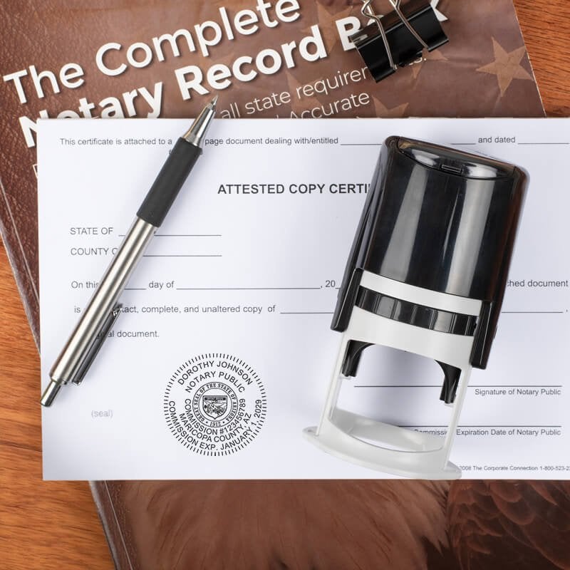 Arizona notary stamp on form with pen and record book on wood surface.