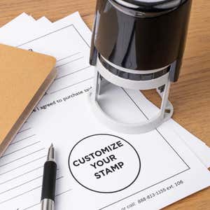 Round custom stamp for personalized logos, displayed on official paperwork; personalized stamp ideal for business branding and document customization.