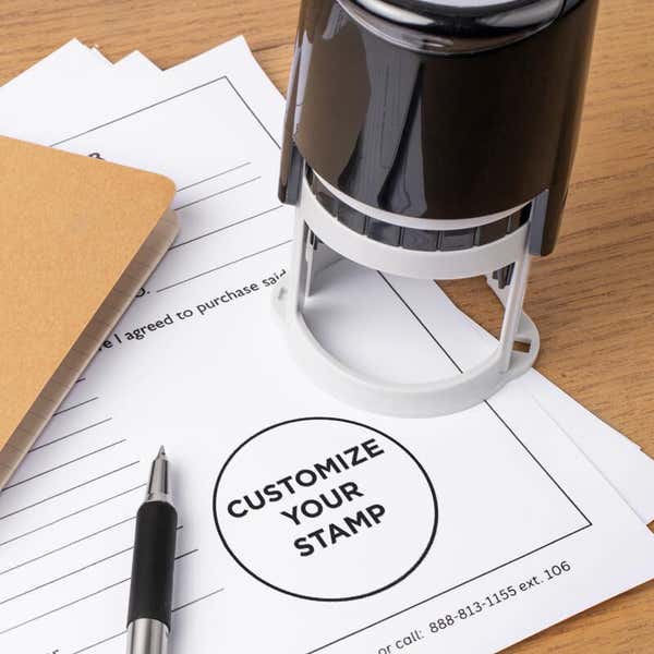 Round custom stamp for personalized logos, displayed on official paperwork; personalized stamp ideal for business branding and document customization.