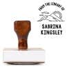 Front view of wood handle stamp body with library book stamp impression
