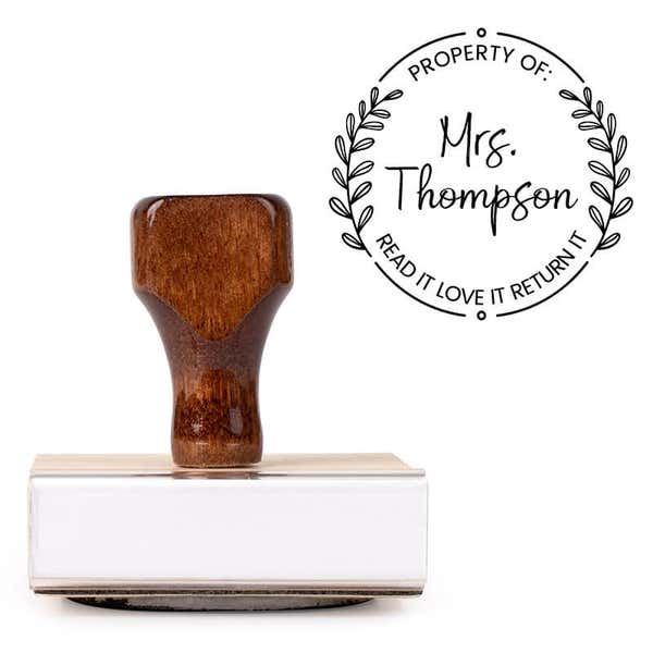 Front view of wood handle stamp body with library book stamp impression
