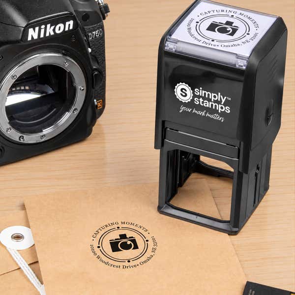 Orbital Round Logo Address Stamp in use, with a stamped logo impression on packaging