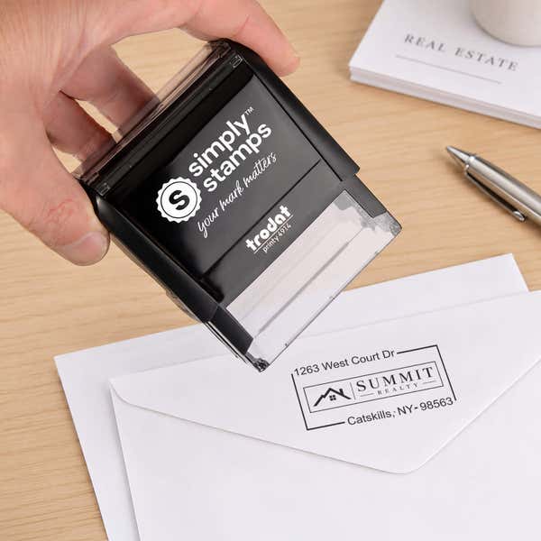 Self-Inking Logo Address Stamp in use, with a stamped logo impression on packaging