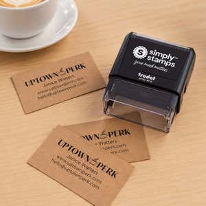 Custom Rectangle Logo Stamp with 3 Lines of Text shown in a workspace beside a freshly stamped logo impression