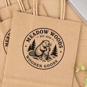 Large Round Logo Stamp in use, with a stamped logo impression on packaging