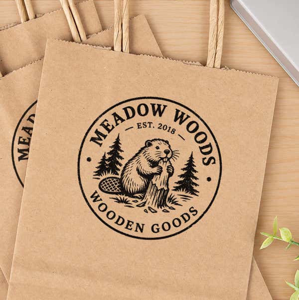 Large Round Logo Stamp in use, with a stamped logo impression on packaging