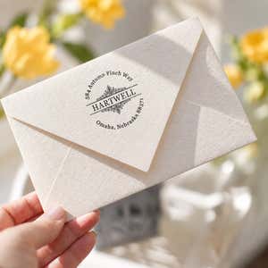 Hand holding an envelope stamped with the Ramsey Vintage Deco Address Stamp